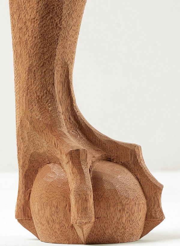<p>Carved foot in the form of the claw of an animal or bird holding a ball, the ball resting on the floor; May have originated in Europe from a Chinese decorative motif of a dragon's claw grasping a pearl</p>