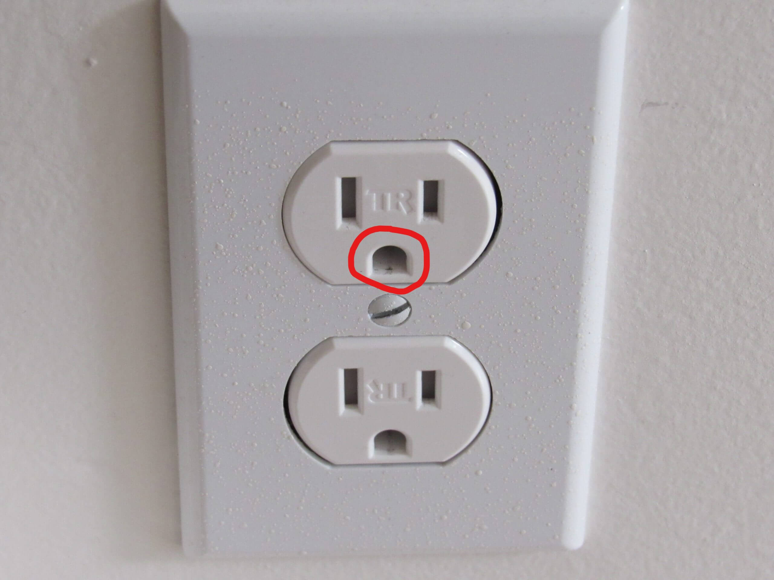 <p>Ground hole. They’re a safety part of an outlet. It gives electricity a safe path to the ground if there’s a fault (mistake in a circuit)</p>