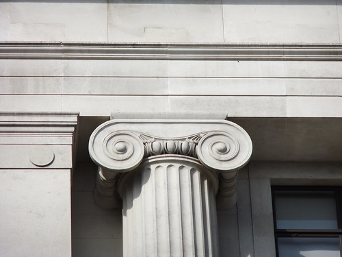 <p>characterized by volutes (spiral, scroll-like form), capitals, columns with bases, uninterrupted frieze, base</p>