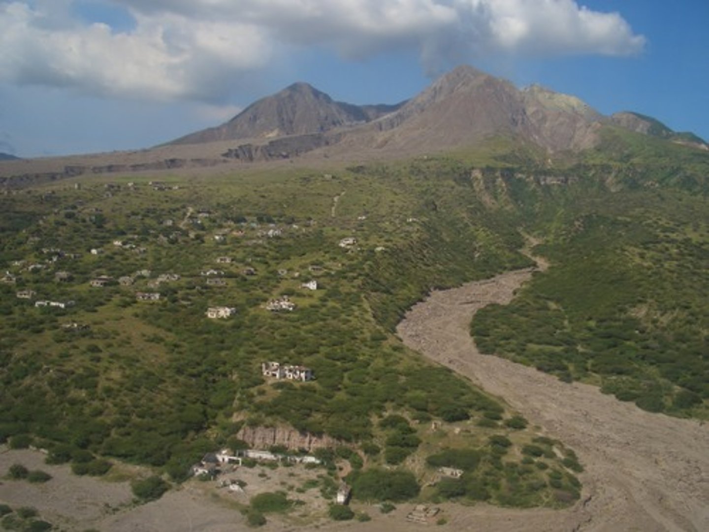 <p>a volcanic mudflow of debris mixed with water, covering the land in thick, dark volcanic material.</p>