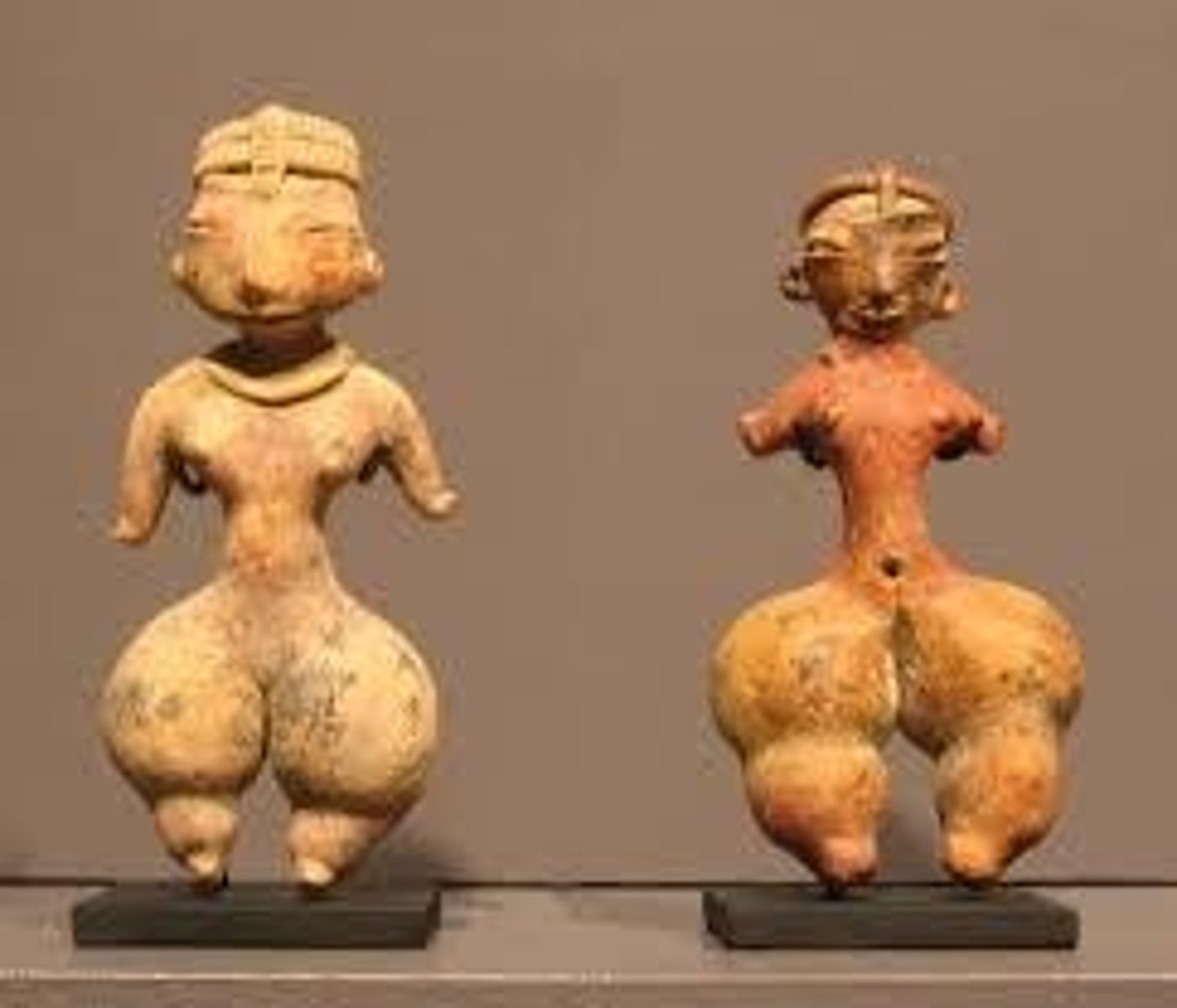 <p>Ceramic figures depicting elaborate hairstyles and body ornaments, some showing deformities.</p>