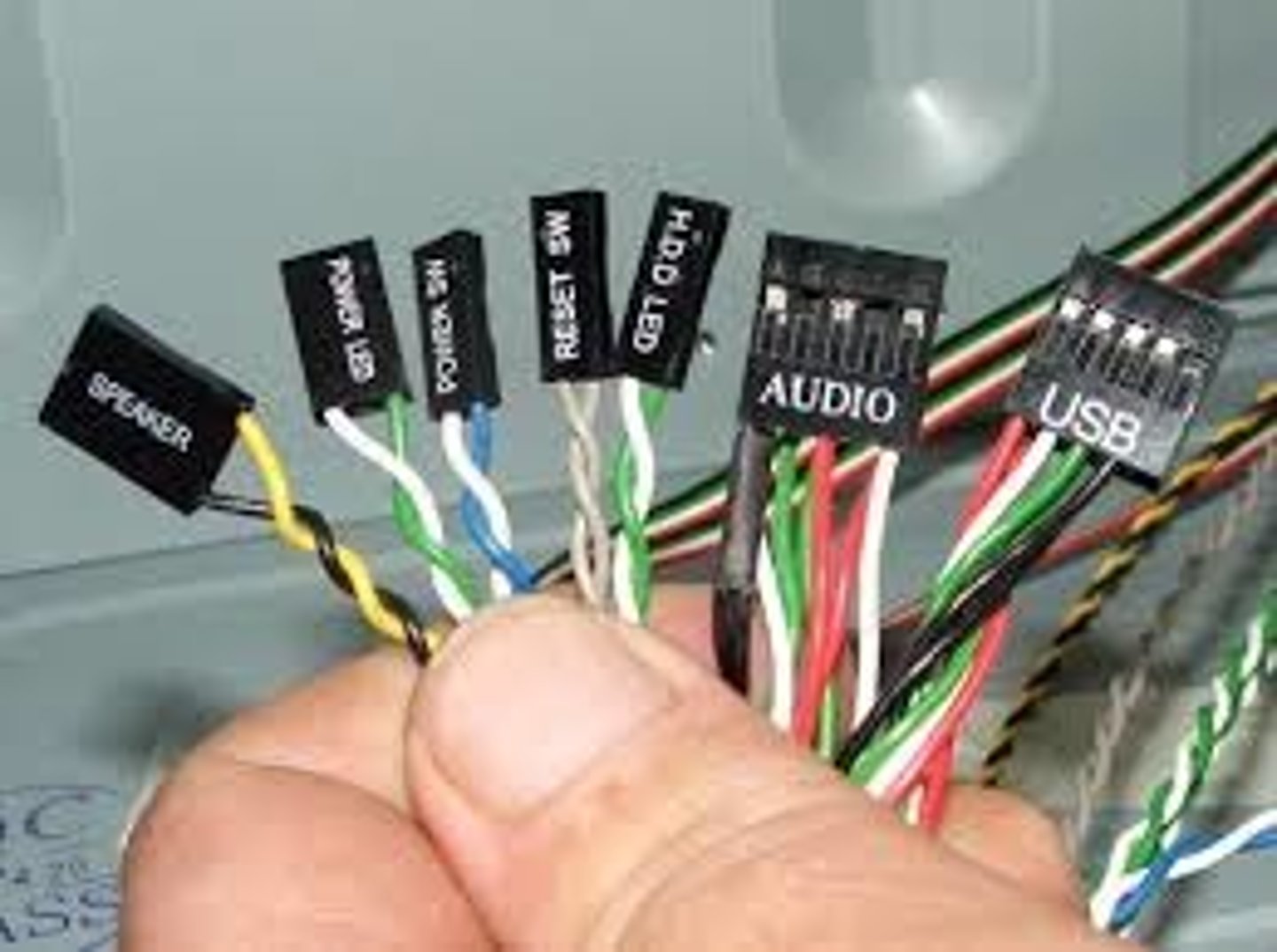 <p>A group of wires running from the front of the computer case to the motherboard</p>