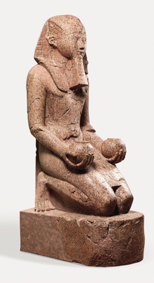 <p>(New Kingdom, c. 1473-1458 BCE. Granite)</p><p>Content: Hatshepsut kneeling, offering jars to Amun; depicted with male pharaonic attributes (nemes headdress, false beard).</p><p>Form: Carved granite; rigid, idealized pose; powerful symbolism of kingship.</p><p>Function: Displayed in her mortuary temple; emphasized her legitimacy as pharaoh despite being female.</p><p>Context: Shows how Hatshepsut navigated gender expectations in art; blended female identity with traditional male pharaoh imagery.</p>