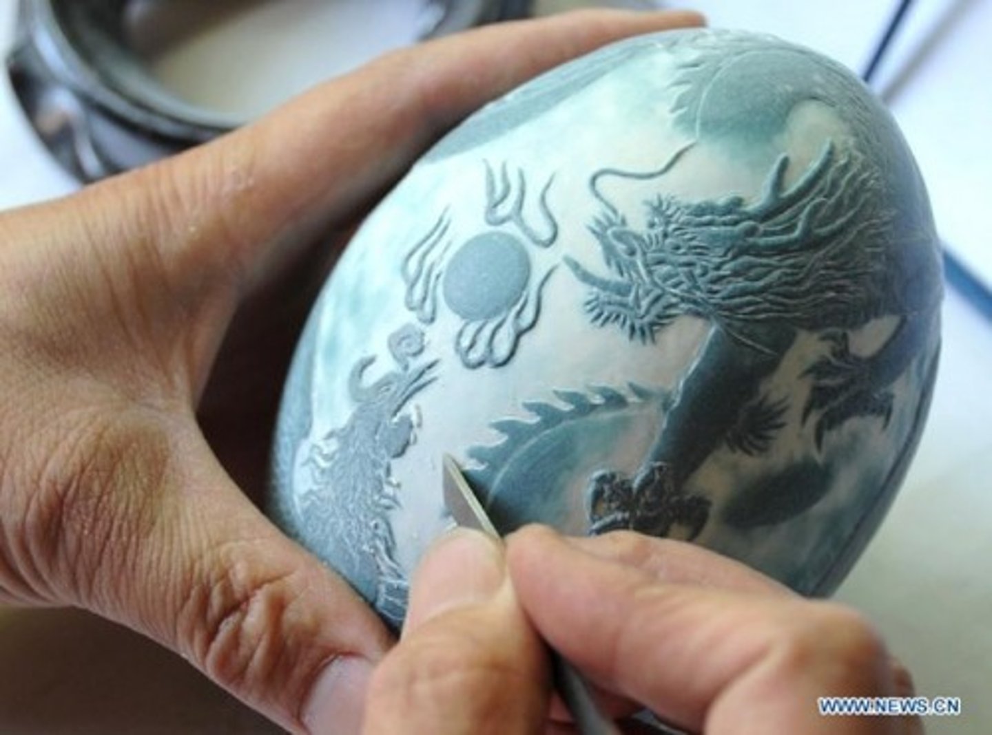 <p>to cut and shape hard material (khắc, tạc, chạm trổ). Example: Ancient people used tools to carve images onto stone walls.</p>