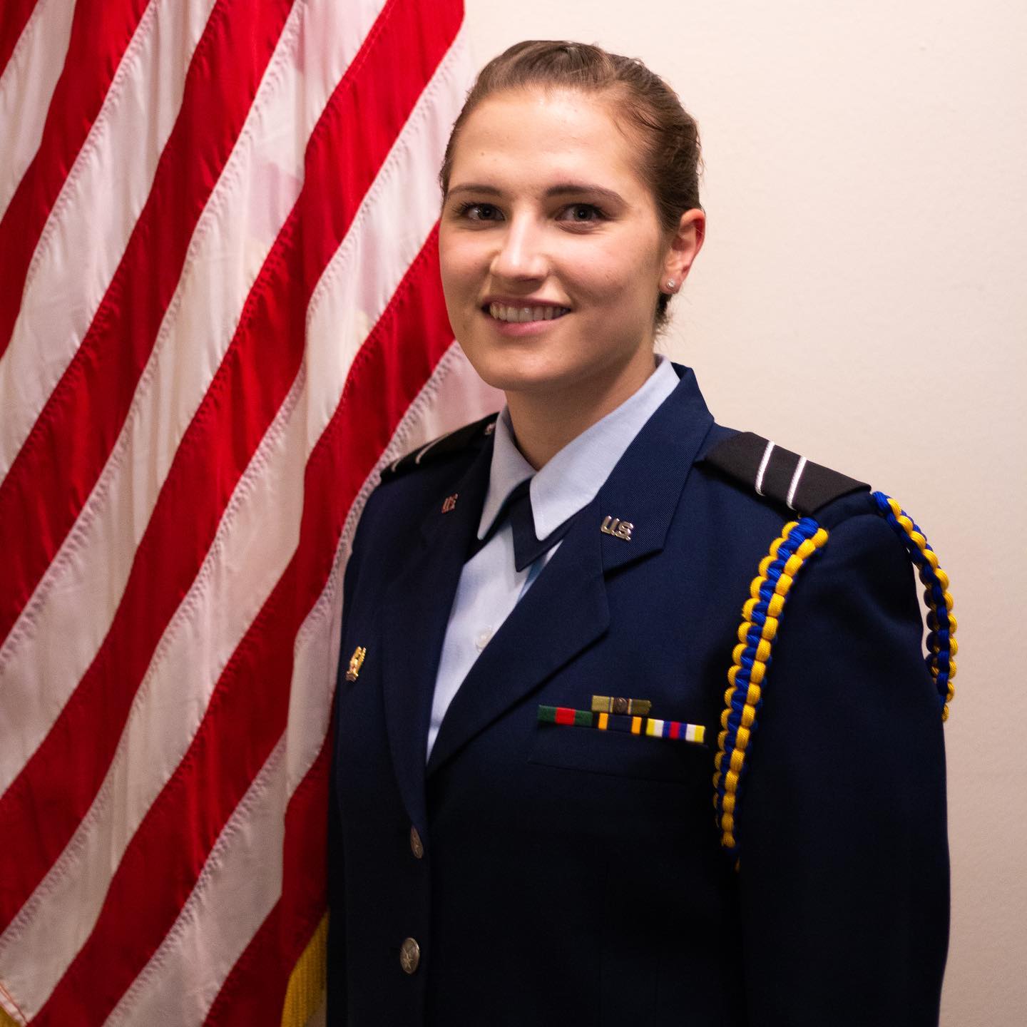 <p>blue and gold braided cord worn around the left shoulder of the service coat and blues shirt</p>