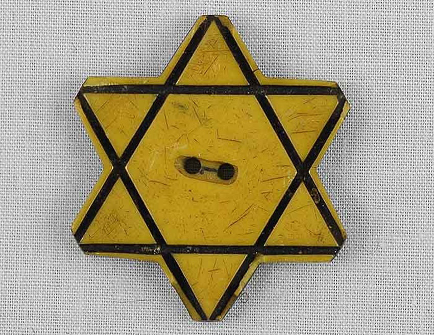 <p>More and more restrictions placed on Jews: curfews, business restrictions, banned from parks, schools, etc. What was the badge Jewish males and females age six and older were required to wear on their clothes?</p>