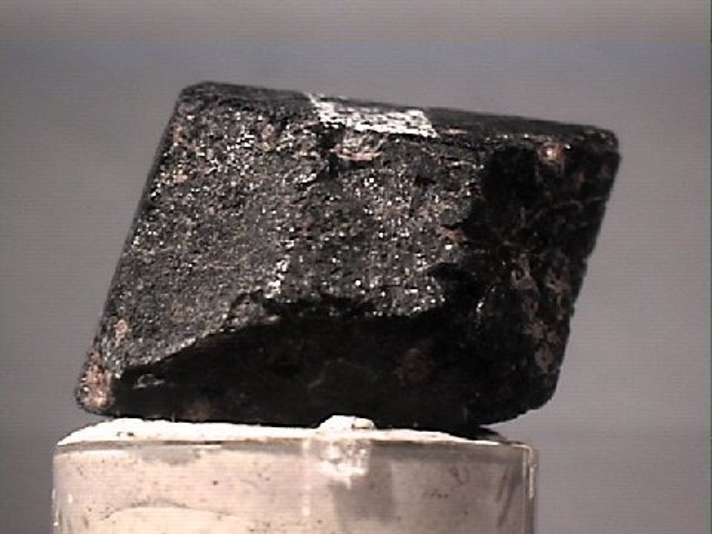 <p>Nondescript black rock, greenish tinge and cleavage at a right angle.</p>