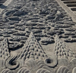 <p>Behind the Hall of Preserved Harmony, in the center of the stairway, is a huge marble relief of nine dragons playing with pearls.</p><p>It is the largest stone sculpture in the Forbidden City. Sculpted originally in the Ming dynasty, it was re-sculpted in the Qing dynasty. </p><p>During these dynasties, anyone who was caught touching this holy stone would receive the death penalty. Weighing about 250 tons, the marble slab is 16.57 meters long, 3.07 meters wide and 1.7 meters thick.</p><p>The huge stone was hauled into the palace from Fangshan, up to 70 kilometers from Beijing. This difficult task took about a month employing twenty thousand men and thousands of mules and horses. </p><p>It is said that a well was dug every 500 meters along the way and the well water was poured on the ground to form an icy road that could facilitate land boat transportation.</p><p></p>