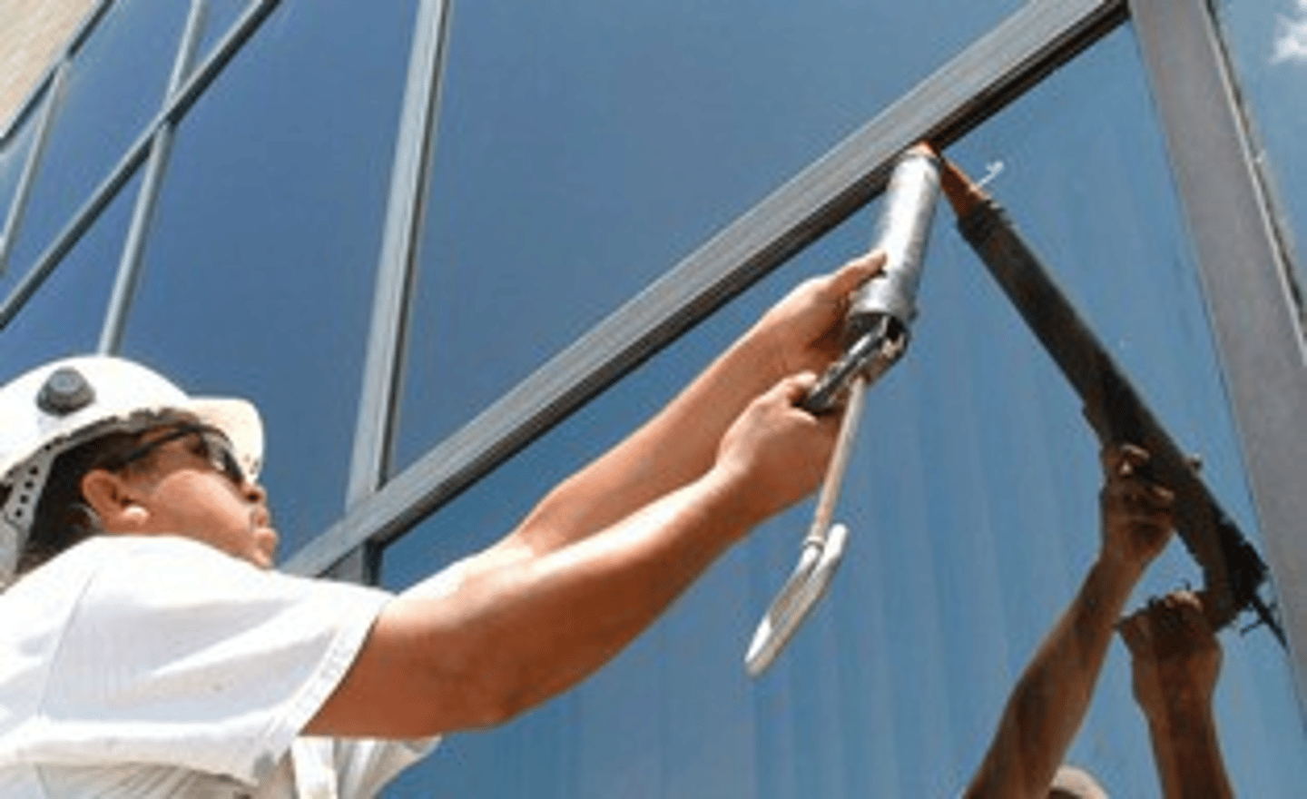 <p>Applying silicone sealant to create watertight and airtight bond between glass and frame</p>