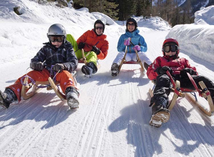 <p>The kids<strong> go sledding</strong> in winter.</p>