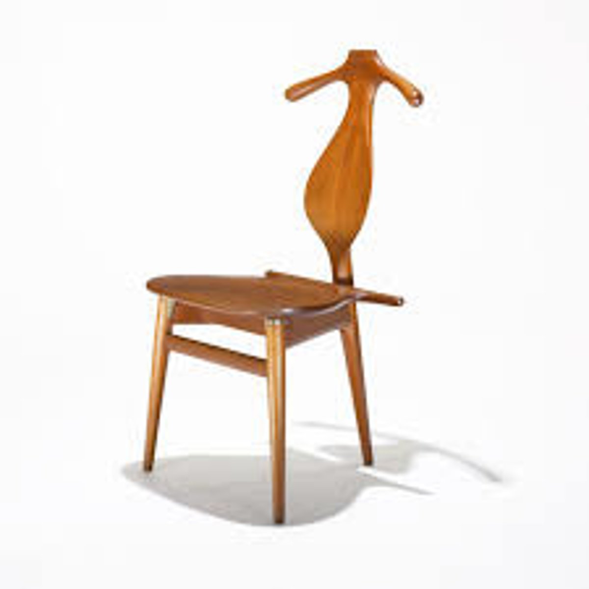 <p>Designed by Hans Wegner in 1953; solves problems in folding clothes in the most practical manner at bedtime. Unites function with a playful sculptural design. The top rail is shaped as a coat hanger while the seat is basically a box for storing.</p>