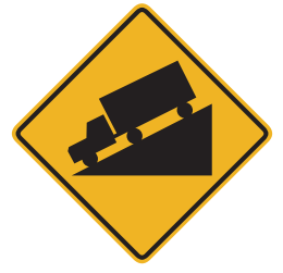 The road goes downhill ahead. Slow down and be ready to shif to lower gear to control speed. 