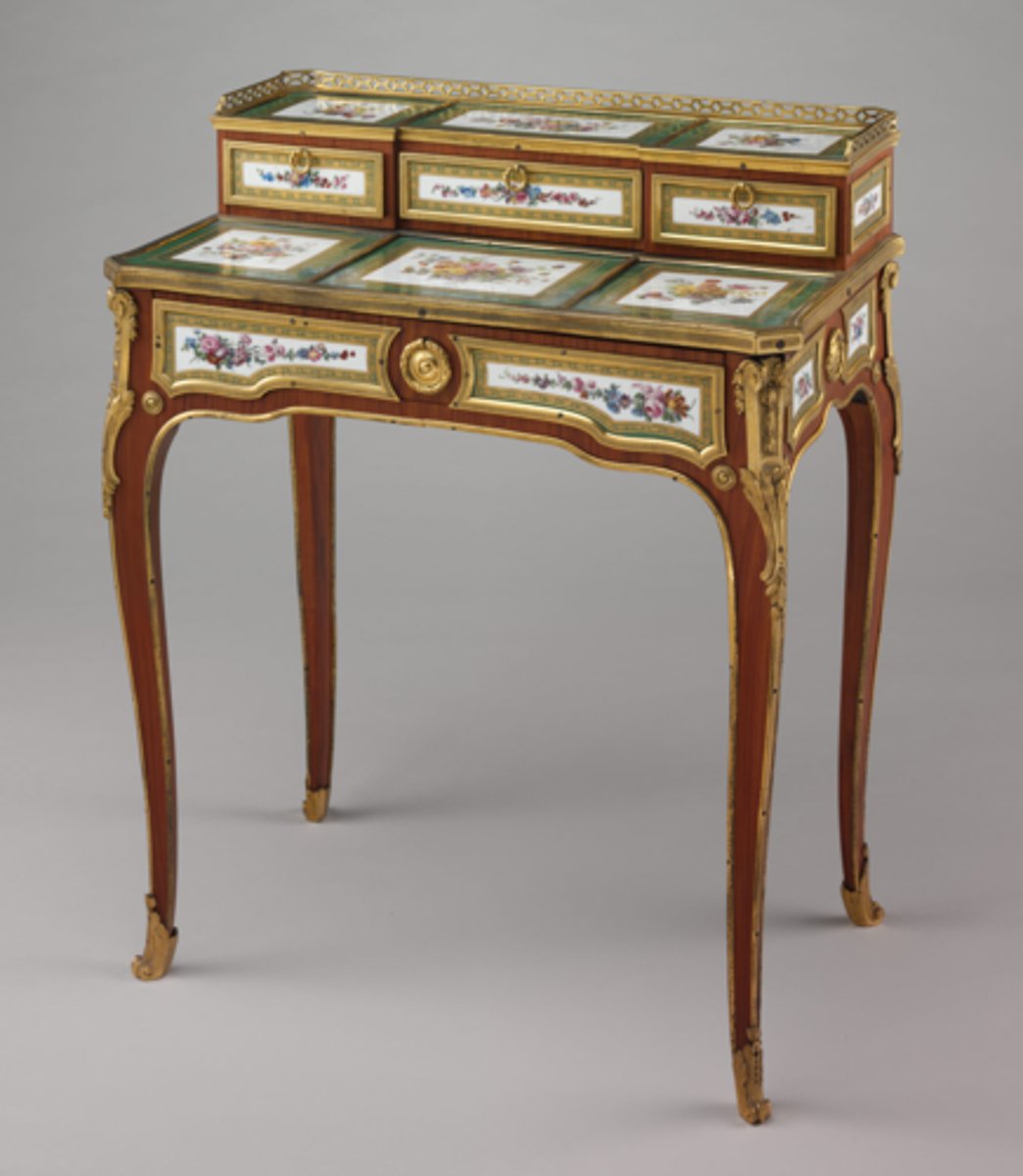 <p>French Rococo (Louis XV)</p><p>a small light lady's writing desk with a central drawer in front, tiered shelves and cupboards at the back, and sometimes, even shelves between the legs (7 days)</p>