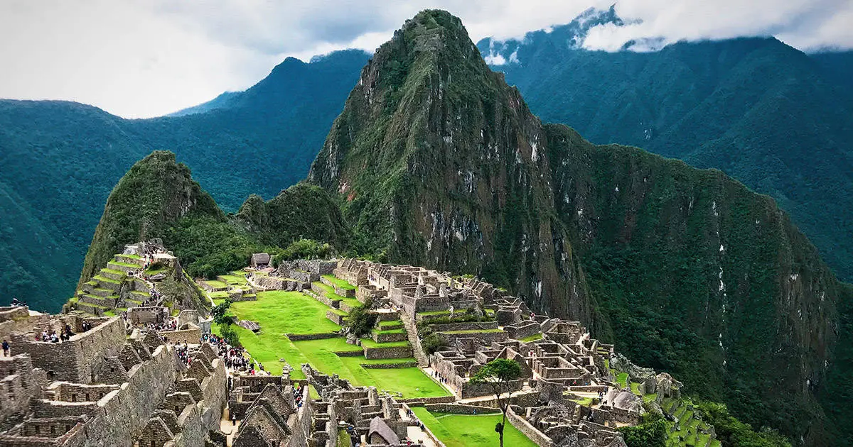 <p><strong>Context: </strong>located at the meeting point of the Peruvian Andes and Amazon Basin. Built in the 15th century and abandoned when the Inka empire was conquered by Spaniards in the 16th century.</p><p>-From the prd of the two great Inca rulers who were centralized/authoritarian</p><p>-Society: emperor (treated like a god), followed by close relatives of the emperor/previous rulers, distant relatives, leaders of conquered peoples </p><p></p><p><strong>Form:</strong></p><p>-200 structures are on a steep ridge crossed stone terraces. Divided into an upper/lower part separating farming from residential and a large square between the two.</p><p>-Blends well with the natural environment with numerous subsidiary (less important but supplementary) structures, extensive roads, irrigation canals, and agricultural terraces. B/c the topography is rugged, there is a mosaic of used/natural habitats → rich diversity of flora/fauna of the Amazon Basin.</p><p>-Terraces: increased arable land surface/reduced erosion. Very important to maize.</p><p>-Stone channels drain rain water to stone fountains</p><p>-Buildings: walls made out of stones individually shaped to fit. Outward faces are smoothed to represent a mosaic and topped with a wood roof. There is a trapezoid entrance/niches/windows. (Cyclopean masonry).</p><p>-Religious structure # is high because the royal family performed rituals to sustain relationships with the supernatural forces that drove existence</p><p>-Temple of the Sun: has an upper curved stone enclosure with windows/niches. The windows were modified to signify the Summer Solstice.</p><p>-Observatory: embodied cosmological thought and facilitated astronomical observation. Pachacuti claimed to be the descendant of the sun god (Inti), so it was adjacent to the royal residence.</p><p>-Intihuatana stone: ritual area carved boulder=Inca connection with the Earth. Used to track the passage of the sun throughout the year to determine religious events.</p><p></p><p><strong>Function: </strong>royal residence for the first Inka emperor. The emperor/his family would host feasts, perform religious ceremonies, and administer affairs of the empire here. Also has housing for elites, shrines, and signature Inca rock outcrops.</p><p>-Temporary residency. The Great Plaza was in the center, and the emperor’s residence to the SW, while high-status residential to the NE</p>