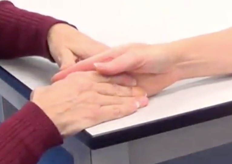 -Forearm in mid position with their thumb touching their index finger
