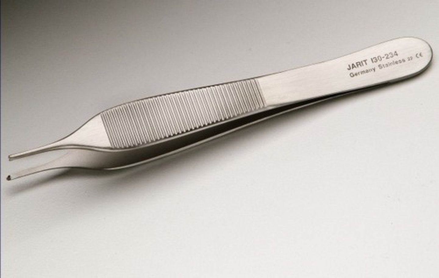 <p>A lab instrument with flexible metal or plastic arms used to pick up, hold and move small items.</p>