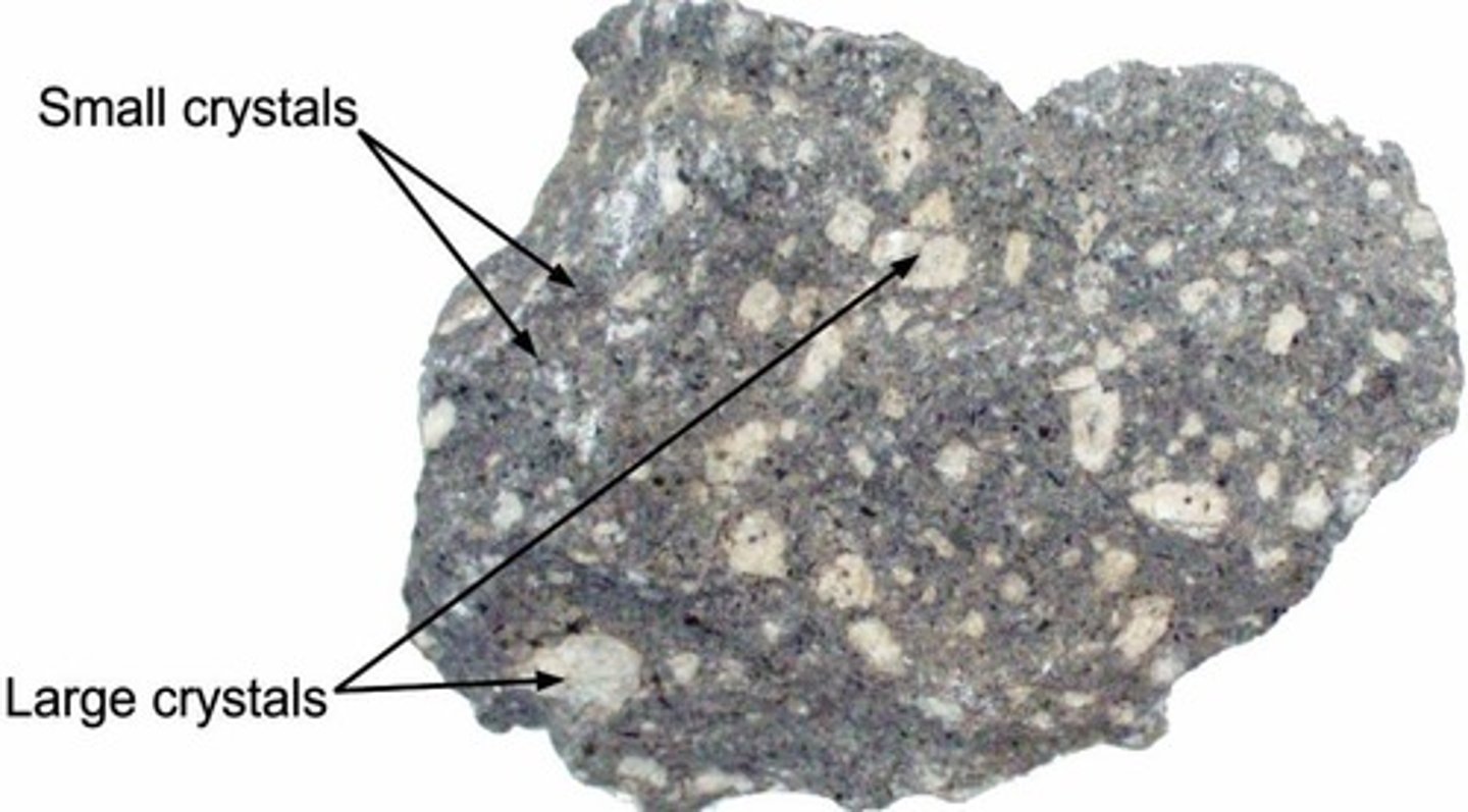 <p>Mixed course and fine grained material. EX: like a chocolate chip cookie</p><p>This indicates two different phases of crystalization.</p>