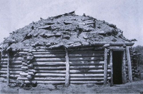 <p>A Navaho Indian dwelling made of earth and logs, covered with mud and sand.</p>