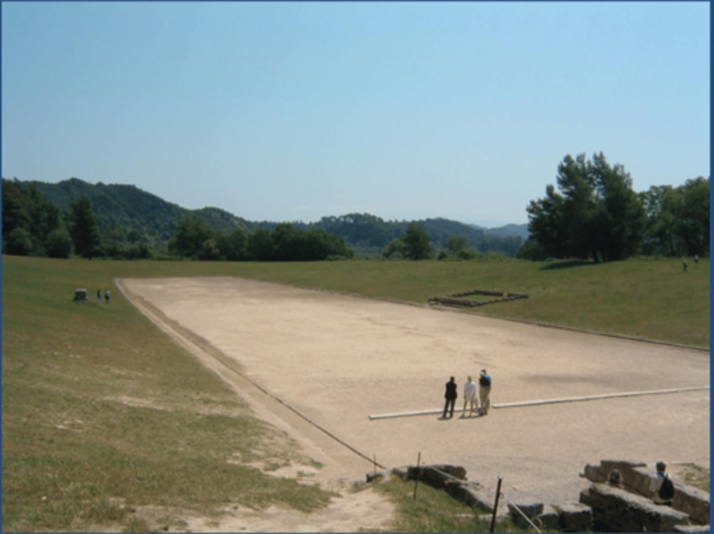 <p>An ancient Greek elongated sports venue with rounded ends, surrounded on all sides by banked spectator stands; venue for foot racing</p>