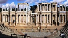 permanently decorated rear stage wall, columns and statues, built of wood and stone. three rear entry arches and two side entry arches