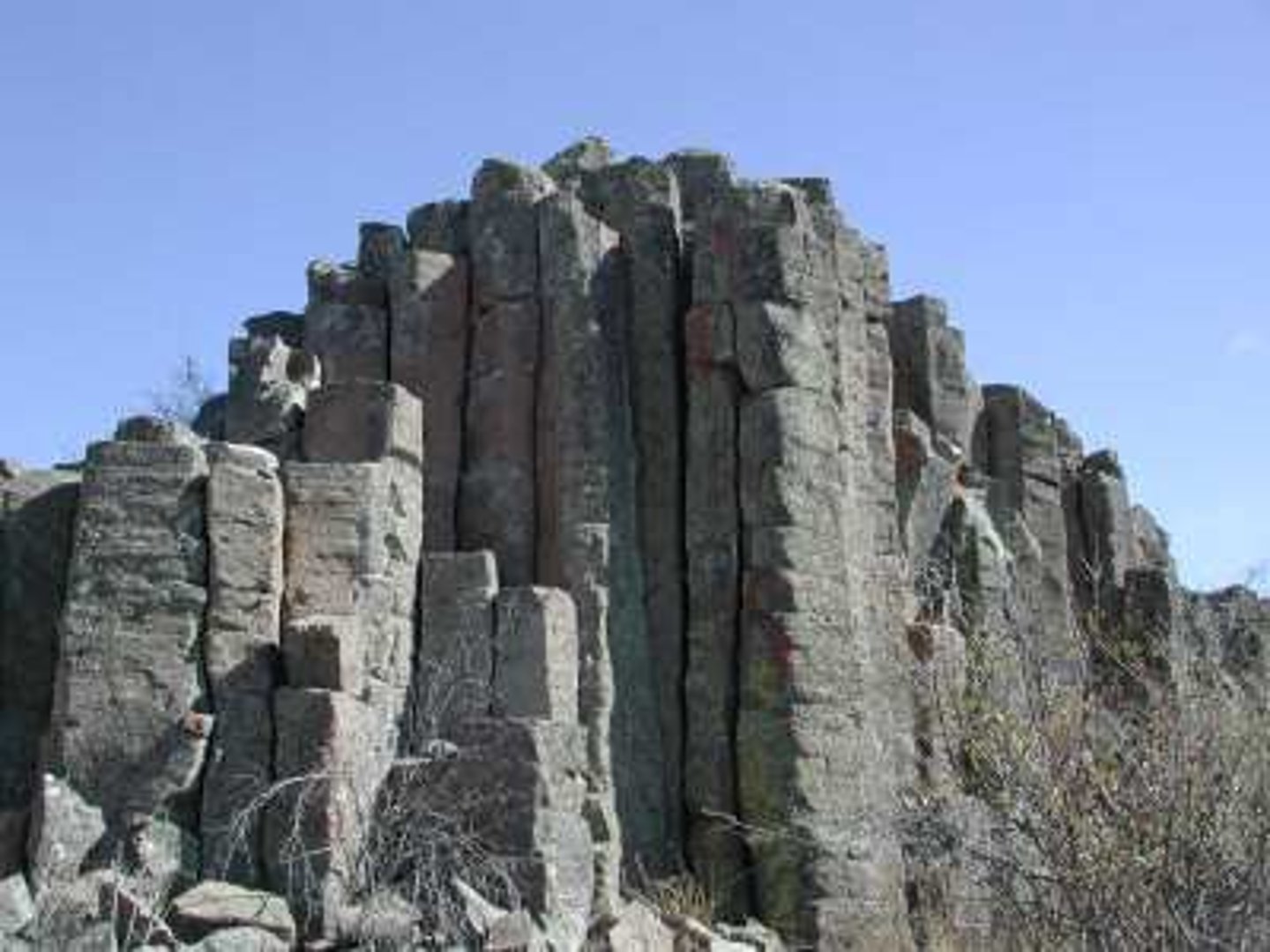 <p>a vertical crack within a rock, such as limestone, which result from the natural shrinking of the rock over time as it was formed; these may form weaknesses allowing water to penetrate the rock</p>