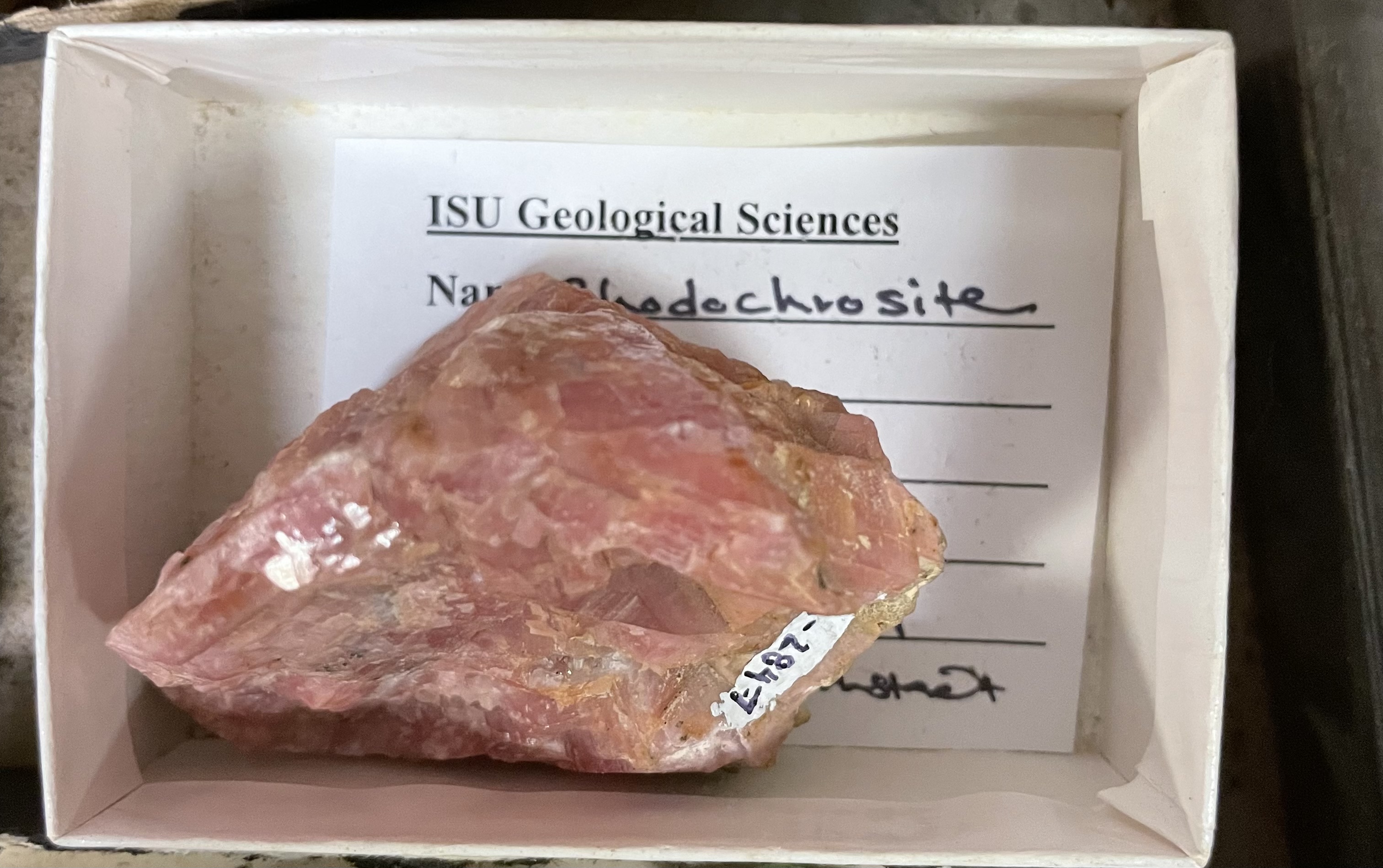 hardness 3.5-4, perfect cleavage or fracture, vitreous luster, pink or red color, white streak, reacts with HCl if powdered