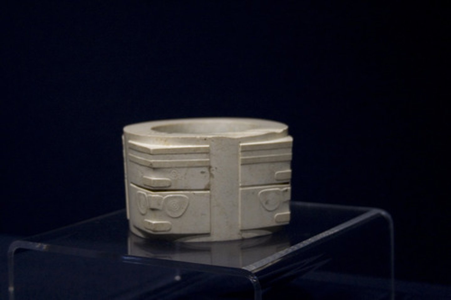 <p>jade; abstract design; face pattern<br>PURPOSE: funerary purposes (burn incense); found by a gravesite; placed around bodies; jade linked w/ virtue, durability, subtlety, and beauty</p>