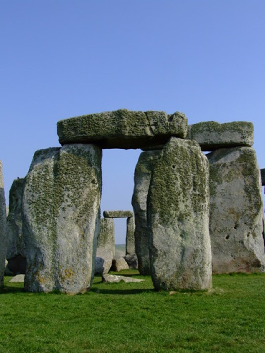 <p>a structure consisting of two large vertical stones (posts) supporting a third stone set horizontally across the top (lintel)</p>