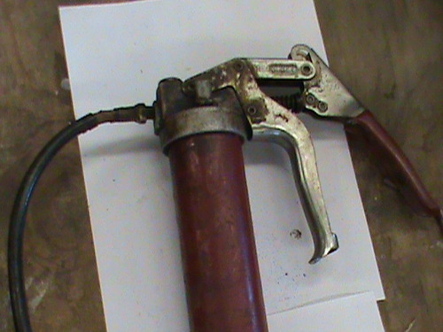 <p>lubricating through grease fittings</p>
