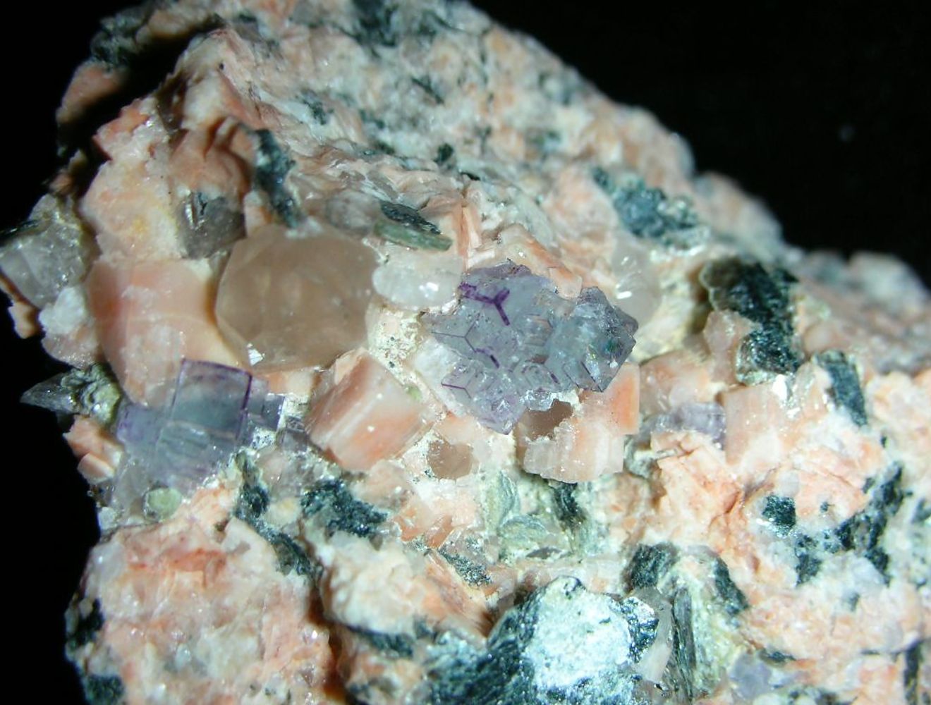 <p>pure fluorite is colorless, this is green, white, yellow, 4.0 hardness, kind of vitreous</p>