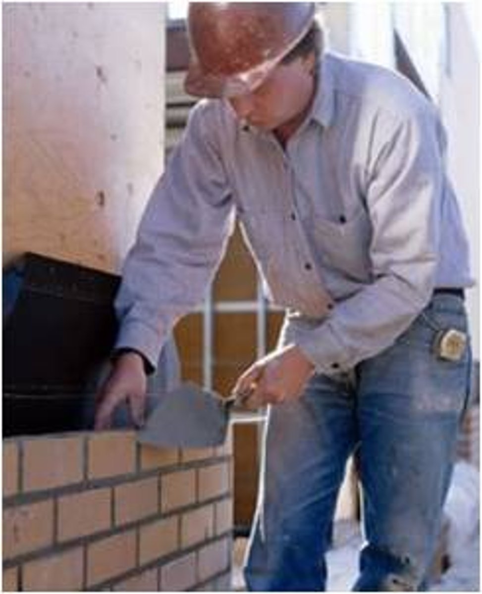 <p><strong>paste-like mixture</strong> of sand, water, lime, and cement used in building for holding bricks and stones together</p>