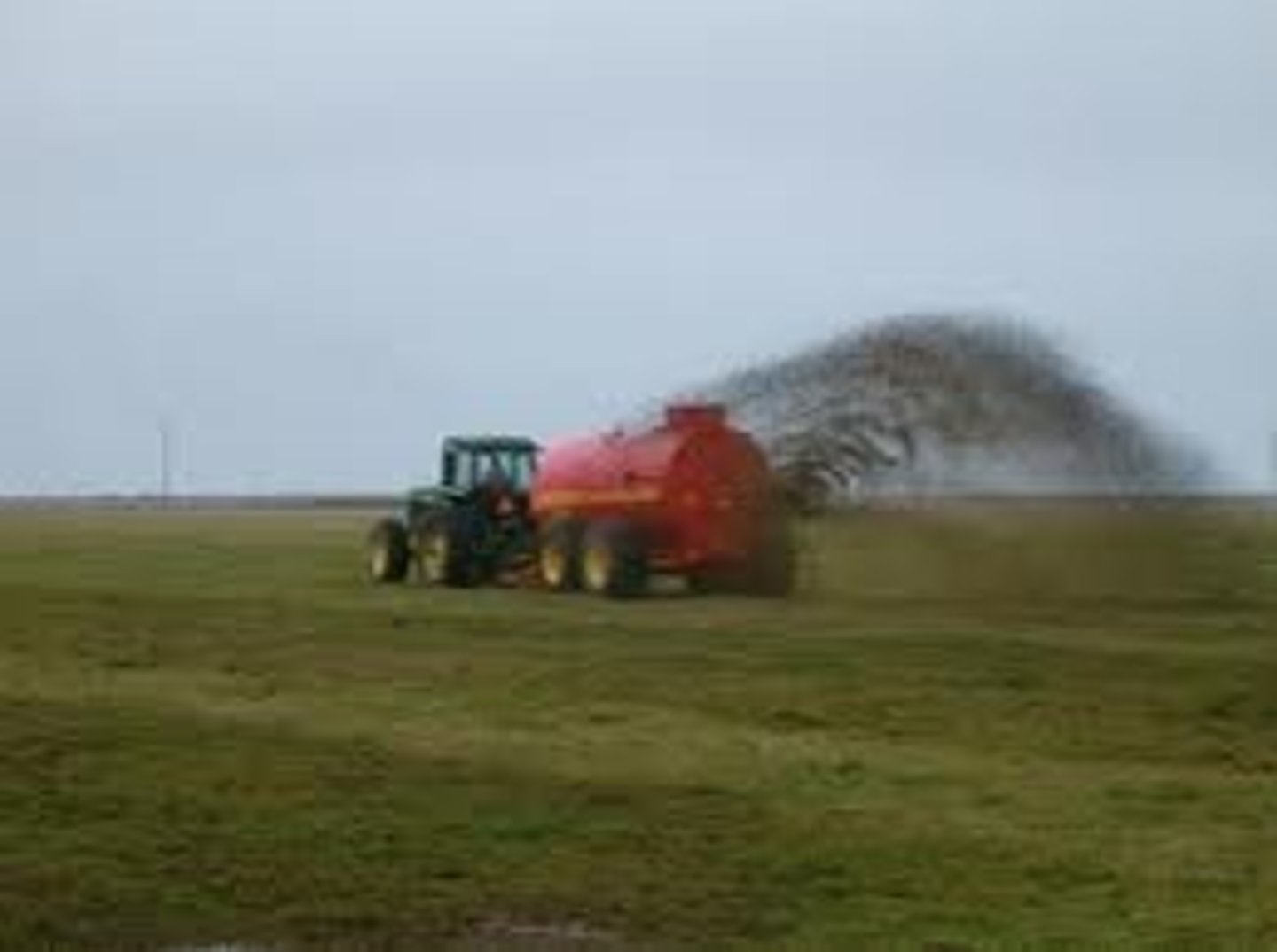 <p>an agricultural machine used to distribute manure over a field as fertilizer</p>