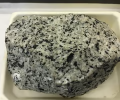 <p>igneous, dominant minerals are orthoclase, quartz, biotite, and hornblende. coarse-grained texture, light color, visible crystals.</p>