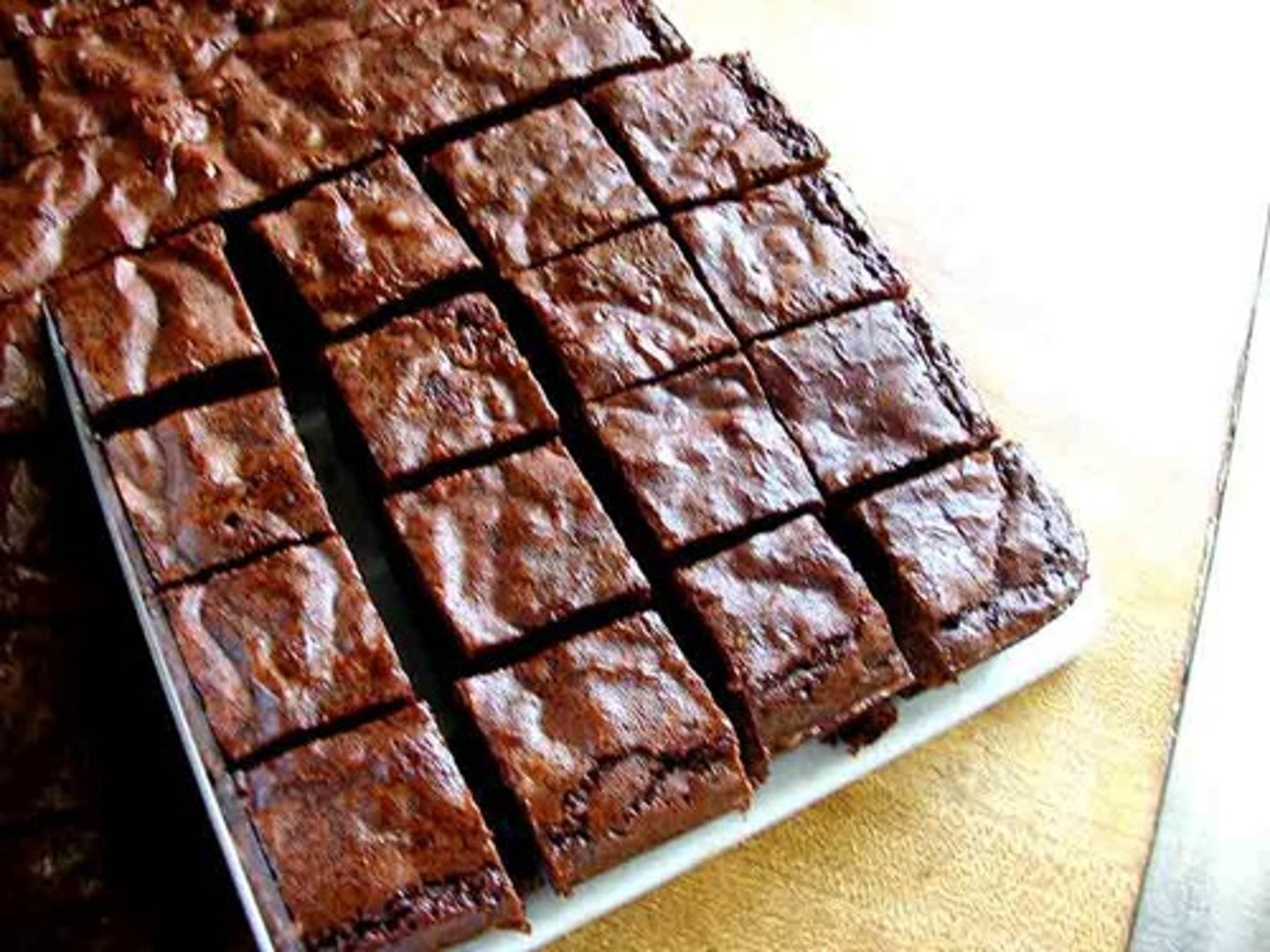 <p>Preheat the oven to 350 degrees. Next, butter a 13X9 glass pan. While the oven heats, begin mixing the dry ingredients. The next step is to blend the eggs, sugar, and vanilla. Set aside.</p>