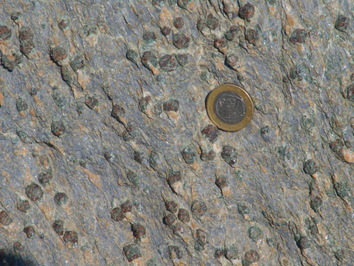 <p>Dark rock which has small purple-red crystals embedded in its surface.</p>