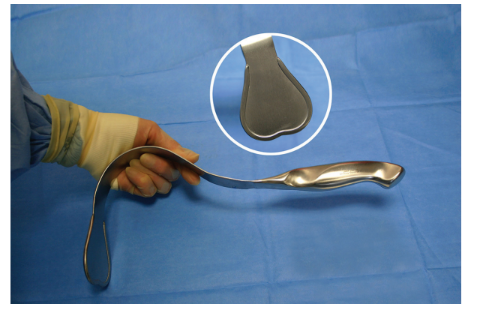 <p>Nickname: Sweetheart</p><p>Use: Retraction of deeper tissue. Shown holding working end and as if passing to the surgeon.</p><p>Features: Smooth heart-shaped working end with protective raised piping</p>