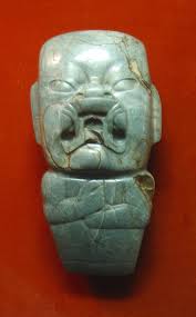 <p>Middle Formative. Jade celt depicting howling baby face</p>