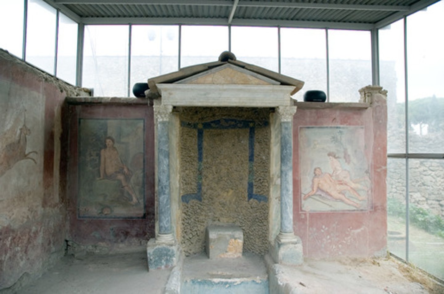 <p>a miniature building or architectural frame; often a niche marked by columns and pediments</p>