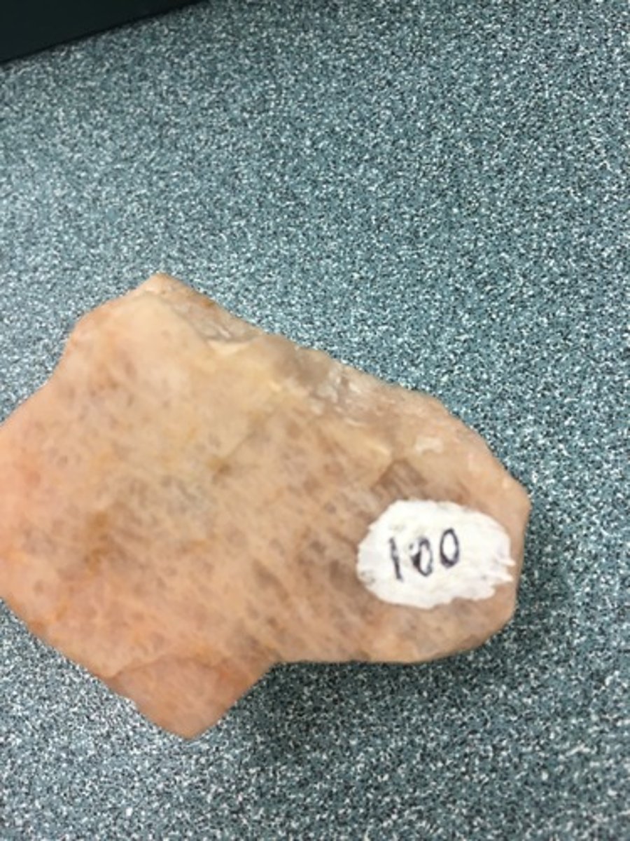 <p> salmony/peachy, perthitic texture, 2 cleavage at 90</p>
