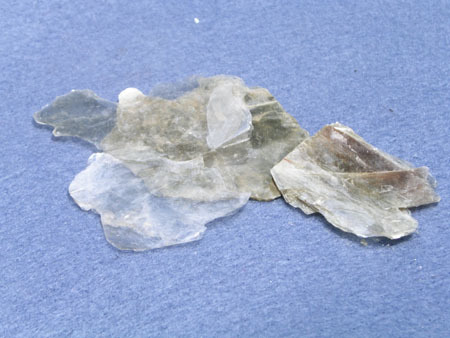 Luster: non-metallic
Hardness: 1
Breakage: cleavage
Streak: pale beige 
Color: Silver/tan/beige 
Thin Sheets