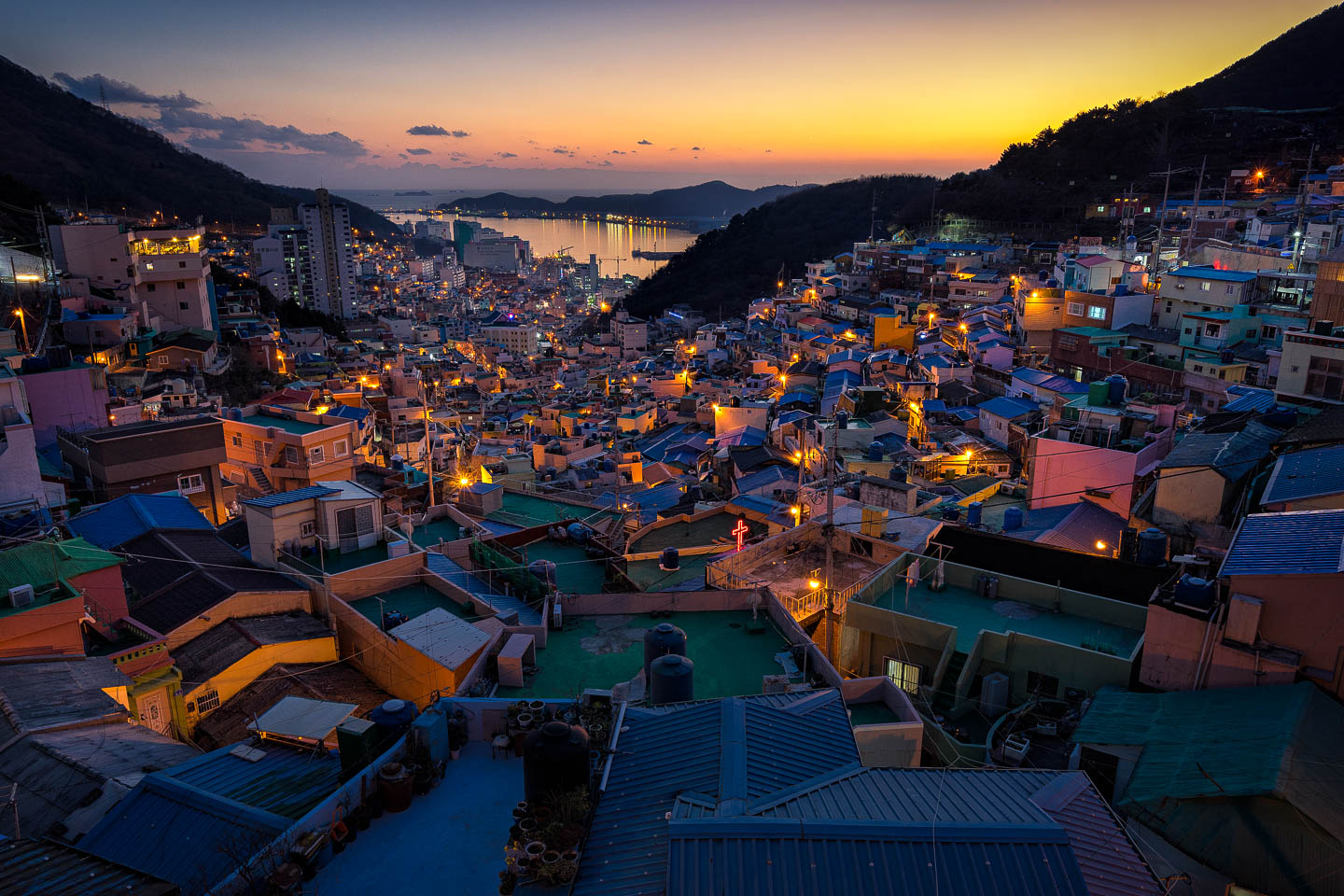 <p>More of the image is in focus. Achieved with a smaller aperture, or a shorter lens/focal length</p>