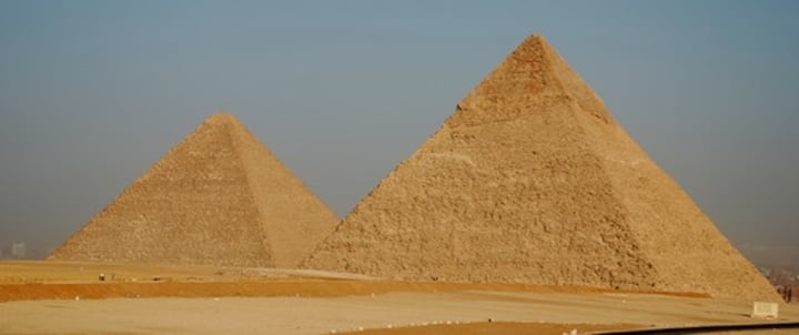 <p>Huge, triangular shaped burial tombs of Egyptian pharaohs built during the Old Kingdom</p>