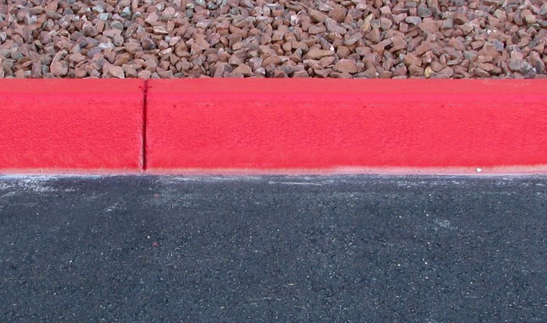 Next to a red painted curb
