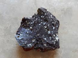 <p>-igneous</p><p>-volcanic</p><p>-amygdaloidal</p><p>-mafic</p><p>-Ca-plagioclase, pyroxene, olivine</p><p>-forms at beginning of BRS</p><p>uses: construction </p>