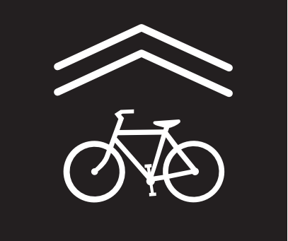 Marked with “sharrows.” These markings alert motorists that bicyclists may use the entire lane, indicate to bicyclists where to ride, and discourage bicycling in the wrong direction. 
