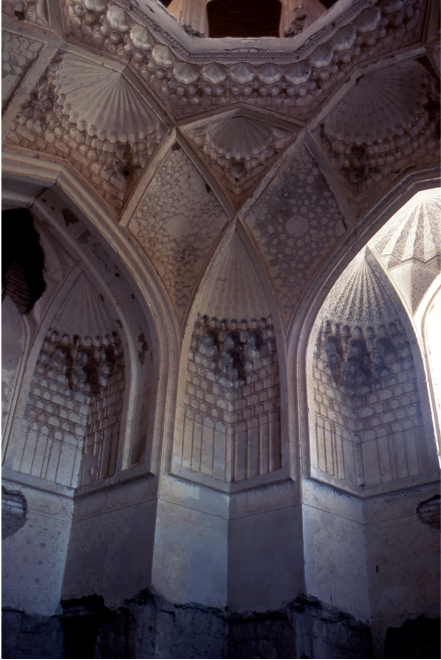 <ul><li><p>Squinch-net from the center of the room</p></li><li><p class="MsoListParagraphCxSpMiddle">The rim around the dome center is ringed by individual muqarnas motifs that resemble a pearl necklace</p></li><li><p class="MsoListParagraphCxSpMiddle">The fan shapes in the high corner elements burst into muqarnas, which then reduce down in 3-dimensionality, ending in a low relief vertical ribbing that echoes the fans at the top</p></li><li><p class="MsoListParagraphCxSpLast">Instead of a closed dome, the ceiling rises to a low lantern with windows that allow in the light</p></li></ul><p></p>