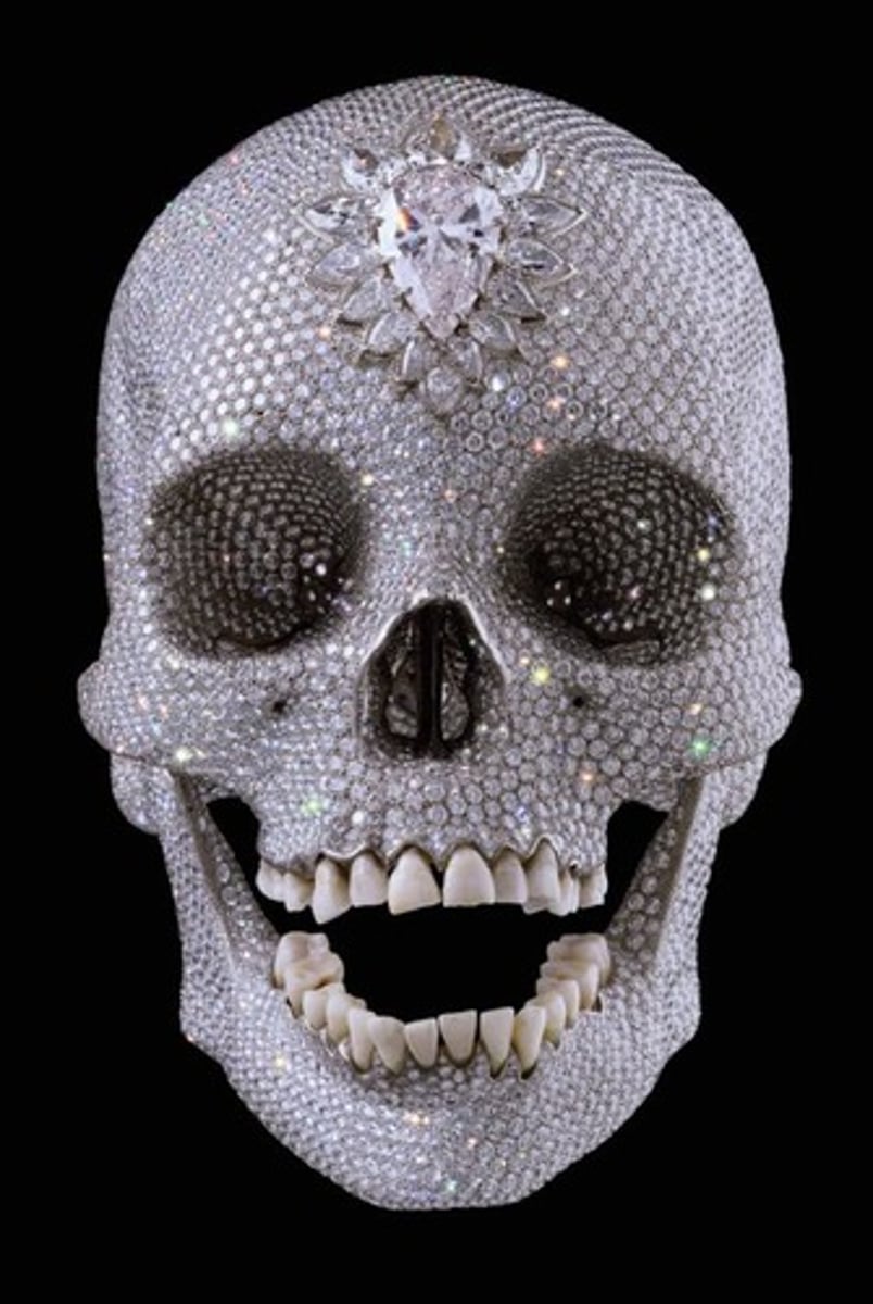 <p>A sculpture by Damien Hirst made from more than 8,600 diamonds, includes real human teeth, and is a platinum skull cast from a real human skull.</p>