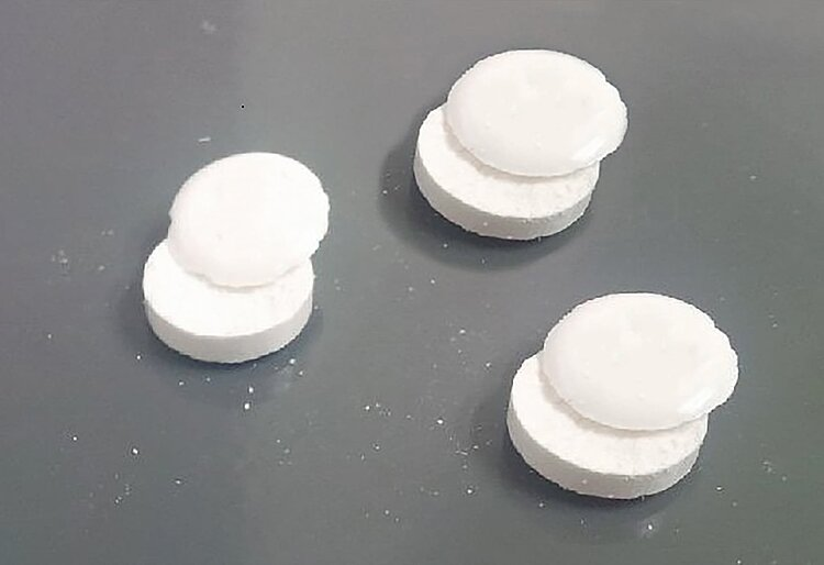 <p>seperation of tab into 2 or more distinct layers </p><ul><li><p>air entrapment </p></li><li><p>too oily</p></li></ul><p></p>