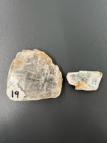 <ul><li><p>clear/white</p></li><li><p>pearly 3 planes of cleavage</p></li><li><p>Hardness: 1.5-2</p></li></ul>