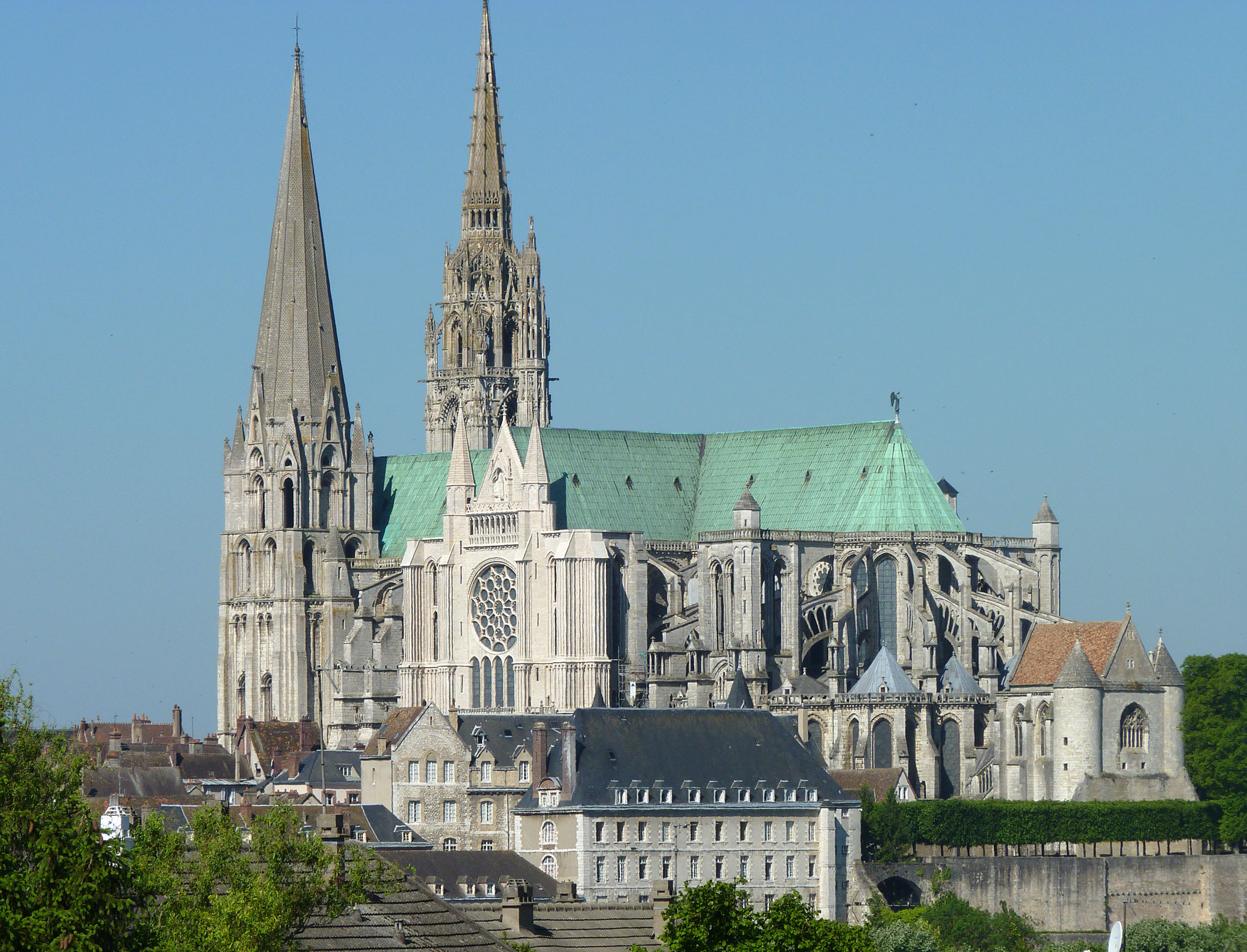 <ul><li><p><u><strong>Form</strong></u></p><ul><li><p>The first church to have flying buttresses as part of the original design; earlier churches retrofitted flying buttresses after the building was constructed.</p></li><li><p>The tall vertical nature of the interior pulls the viewer’s eyes up to the ceiling and symbolically to heaven; rib vaulting increases the ceiling’s vertical thrust.</p></li><li><p>Lancets and spires add to the verticality of the building.</p><ul><li><p><strong>Spire</strong> or <strong>Steeple:</strong> a tall pointed tower on a church</p></li></ul></li><li><p>The dark, mysterious interior increases a spiritual feeling.</p></li><li><p>Stained glass enlivens the interior surfaces of the church.</p></li><li><p>The façade contains a gallery of Old Testament figures above a rose window.</p></li><li><p>Enlarged chevet accommodates elaborate church ceremonies.</p></li></ul></li><li><p><u><strong>Function</strong></u>: Christian church dedicated to the Virgin Mary; a Marian shrine.</p></li><li><p><u><strong>Context</strong></u></p><ul><li><p>Started in 1145; fire in 1194 forced reconstruction of everything except the façade.</p></li><li><p>Mary’s tunic, worn at Jesus’s birth, is its most sacred relic; its escape from a fire in 1194 was seen as a signal to rebuild the cathedral.</p></li><li><p>Right spire is from 1160; left spire is Late Gothic (1507–1513), a style more elaborate and decorative called <strong>Flamboyant Gothic</strong>.</p></li><li><p>Importance of the church reflected in the speed of construction: 27 years.</p></li><li><p>Each wing of the cathedral faces a cardinal direction of the compass:</p><ul><li><p>The <strong>west wing</strong> is the entrance, facing sunset and symbolizing the end of the world.</p></li><li><p>The <strong>north wing</strong> has stained-glass windows that symbolize the past.</p></li><li><p>The <strong>south wing</strong> has stained-glass windows that symbolize the presentworld depicted in the New Testament.</p></li><li><p>The <strong>east wing</strong> has the apse and altar, located where the sun rises.</p></li></ul></li><li><p>Part of a complex that included a school, a bishop’s palace, and a hospital.</p></li></ul></li></ul>